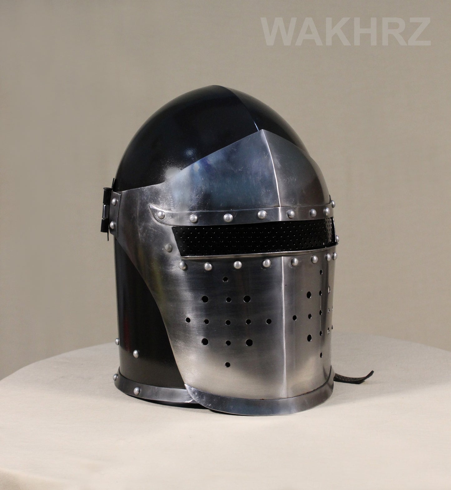 WAKHRZ BURBUTA VISORED CRUSADER HELMET WITH WOODEN BASE.