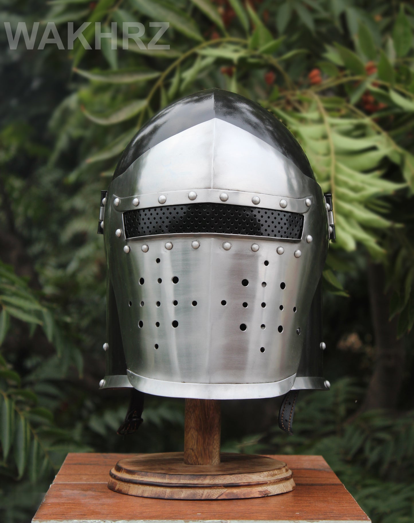 WAKHRZ BURBUTA VISORED CRUSADER HELMET WITH WOODEN BASE.