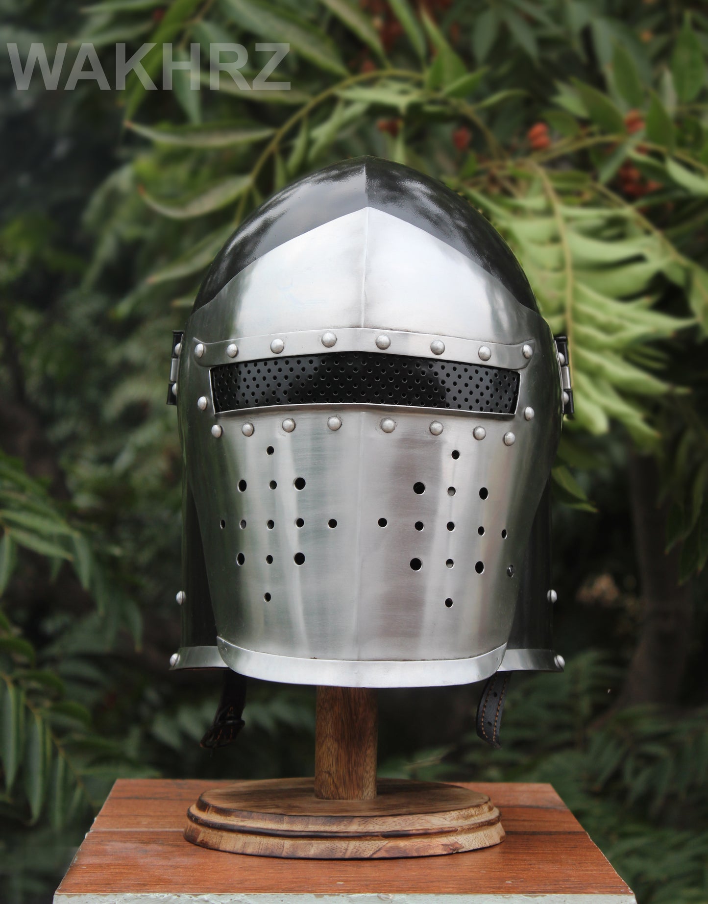 WAKHRZ BURBUTA VISORED CRUSADER HELMET WITH WOODEN BASE.