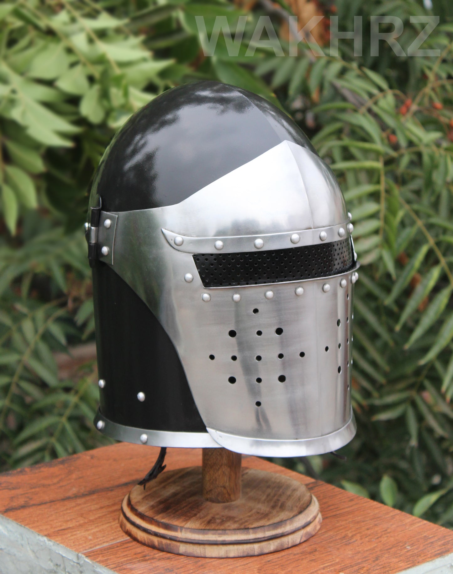 WAKHRZ BURBUTA VISORED CRUSADER HELMET WITH WOODEN BASE.
